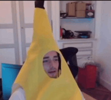 a man wearing a banana costume with a hole in the middle of his head .