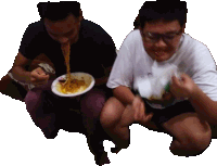 two men are sitting on the floor eating noodles from a plate