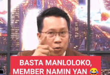 a man with glasses and a sign that says basta manloloko member namin yan behind him