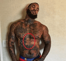 a man with a lot of tattoos on his chest and torso including a picture of obama