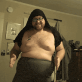 a shirtless man with a tattoo on his chest that says ' g '