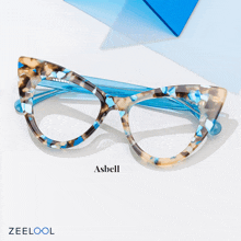 a pair of glasses made by asbell are displayed