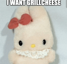 a hello kitty stuffed animal with a red bow and the words i want grill cheese below it