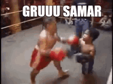 two men are fighting in a boxing ring and the words gruuu samar are on the bottom of the screen .