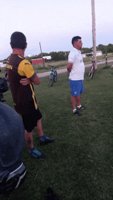 a man wearing a shirt that says nissan stands in the grass