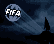 a silhouette of batman stands in front of a glowing circle that says fifa