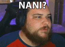 a man with a beard is wearing headphones and has the word nani on his head