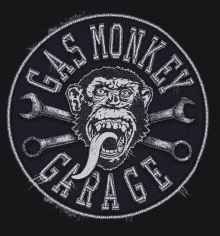 a gas monkey garage logo with a chimpanzee sticking out its tongue