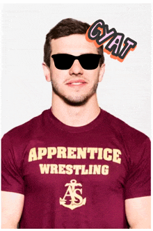 a man wearing a maroon apprentice wrestling shirt