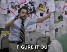 a man standing in front of a bulletin board with the words figure it out written on it