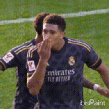 a soccer player wearing a jersey that says emirates fly better on it