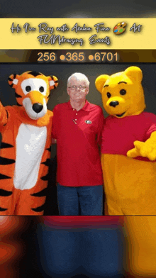 a man in a red shirt stands next to a tiger and winnie the pooh mascot