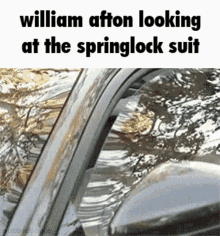 william afton is looking at the springlock suit while sitting in a car .