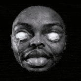 a black and white photo of a person 's face with water drops on it
