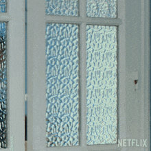 a man is peeking out of a door with netflix written on the bottom