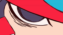 a close up of a person 's eye with a red and blue hat