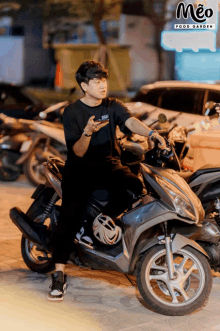 a man is sitting on a motorcycle in front of a meo food garden