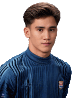 a young man wearing a blue sweater with a thailand emblem on the front