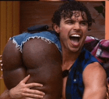 a man is carrying a woman 's butt in shorts