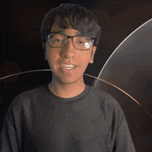 a young man wearing glasses and a black shirt with the word jay on it