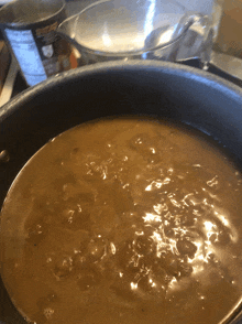 a pot filled with a brown liquid is sitting on a stovetop