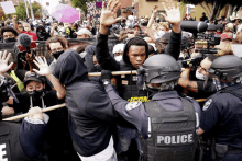 a police officer stands in front of a crowd