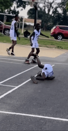 a basketball player with the number 23 on his jersey is laying on the court