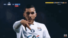 a soccer player is pointing at the camera while wearing a white shirt that says ca on it