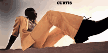 a picture of a man laying on the ground with the name curtis on the bottom