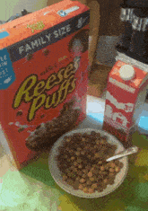 a bowl of reese 's puffs cereal next to a box of cereal