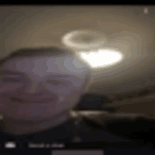 a blurry picture of a man 's face with a light in the background .