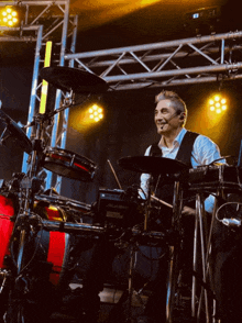 a man is playing drums in front of a drum set that says alesis