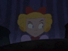 a cartoon girl with blonde hair and a red bow on her head is looking at the camera .