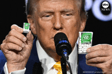 donald trump is holding a pack of tic tac