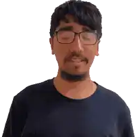 a man with glasses and a beard wearing a blue shirt