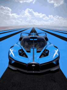 a blue bugatti car is on a track