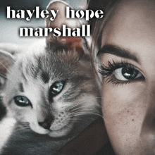 a close up of a woman holding a cat with the name hayley hope marshall above it