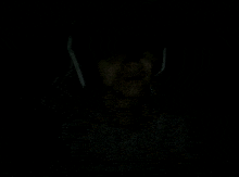 a person wearing headphones in the dark with their mouth open