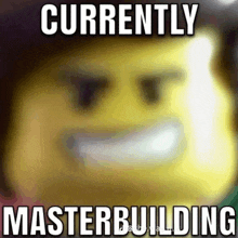 a blurred image of a lego man with the words currently masterbuilding below it