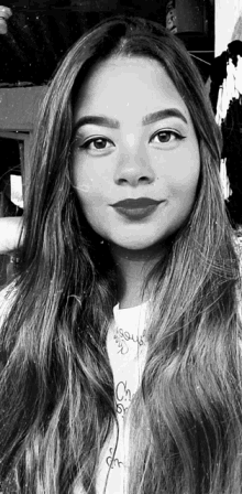 a black and white photo of a woman with long hair wearing a jesus shirt