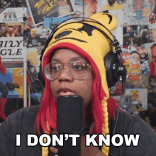 a woman wearing a tiger hat and headphones says " i don 't know "