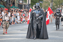 a man in a darth vader costume takes a picture