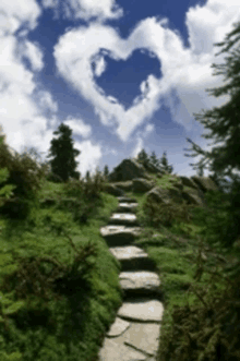 a stone path with a heart shaped cloud in the background