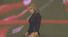a woman is standing in front of a purple background with the word fite on it