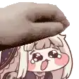 a hand is putting a donut on top of a cartoon character .