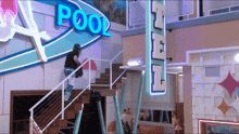 a man climbs the stairs in front of a sign that says pool