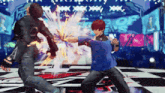 a man in a blue shirt is fighting another man in a black and white checkered floor