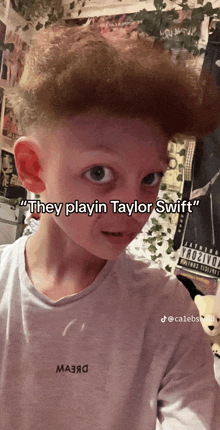 a young boy is wearing a shirt that says they playin taylor swift