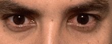 a close up of a man 's eyes with a red eye