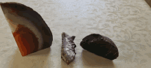 three different colored rocks on a table with a patterned table cloth